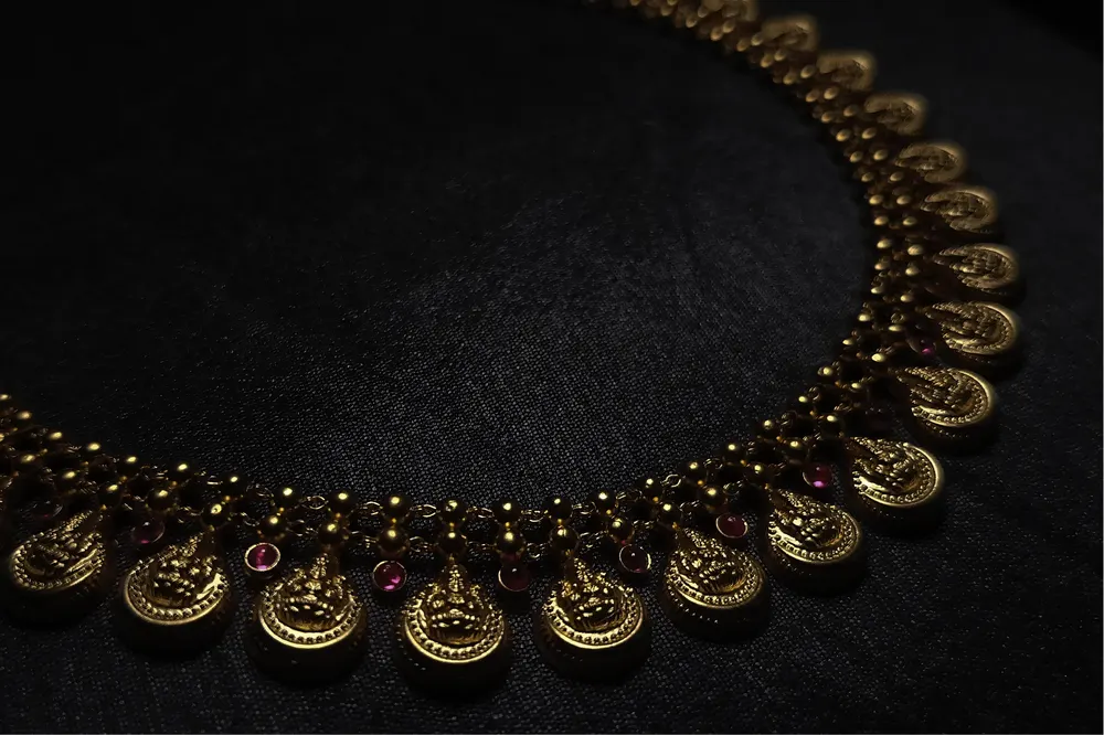 Kasu Mala arc with ruby accents on black