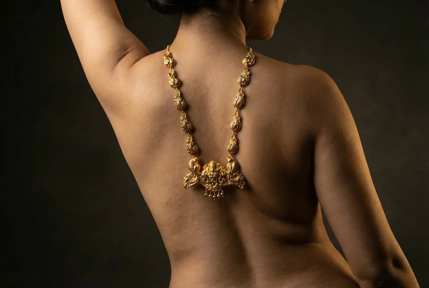 High angle editorial portrait with temple gold jewellery
