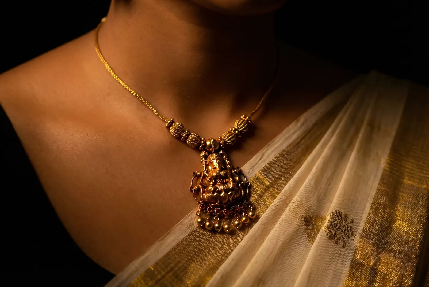 Ganesha deity pendant on white kasavu, devotion