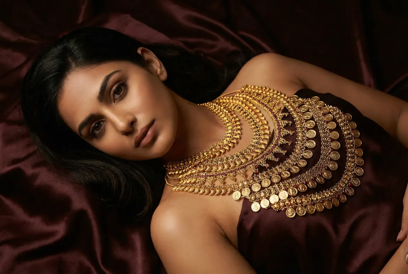 Reclining editorial with Kasu Mala on dark silk
